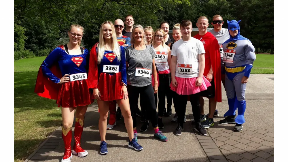 Photo of a group of colleagues in super-hero fancy dress.