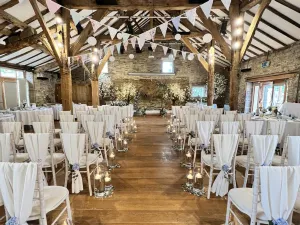 image of the inside of a barn decorated for a wedding ceremony