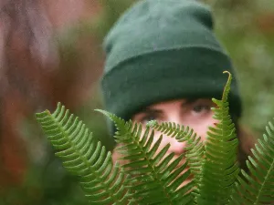 picture of a young white girl holding some fern leaves