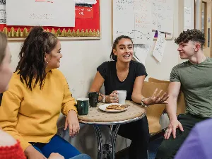 photo of young person talking to peers in a workshop setting