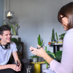 photo of teenage boy talking to therapist