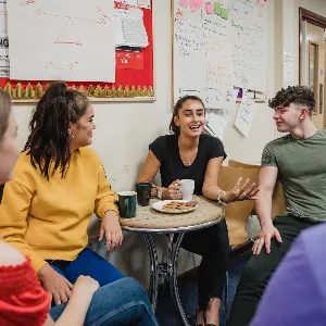 photo of young person talking to peers in a workshop setting