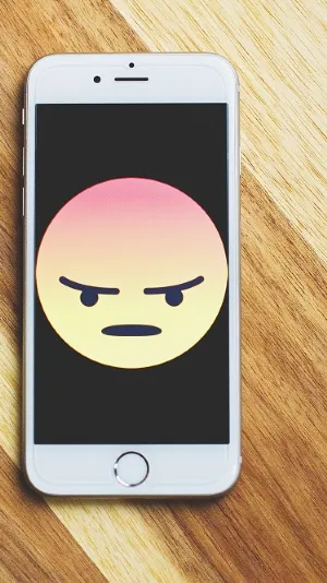 Image of an angry emoticon on a mobile phone