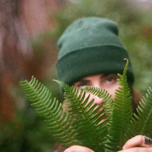 picture of a young white girl holding some fern leaves